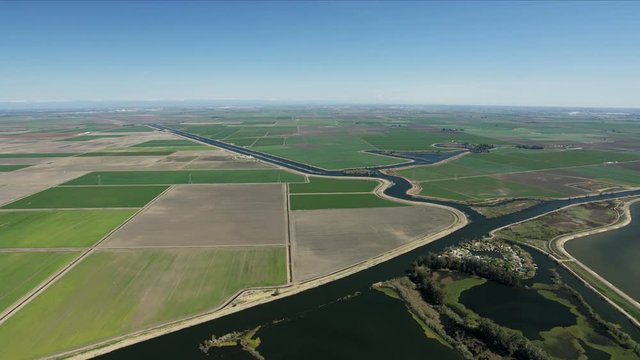 Aerial patchwork crops irrigation aqueduct America farming landscape
