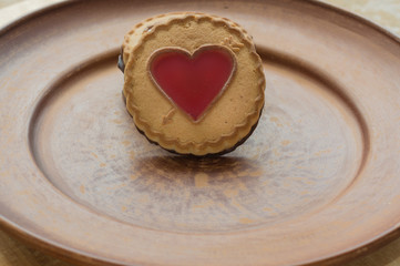 Close up Valentine biscuit on a brown clay plate. Valentines sweet