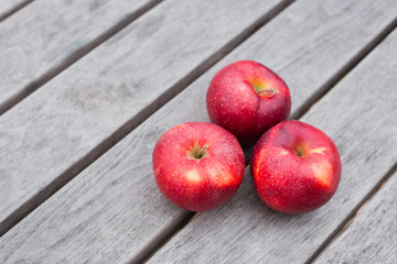 Organic fresh apples on wooden background. Agriculture concept theme with fresh apples in nature