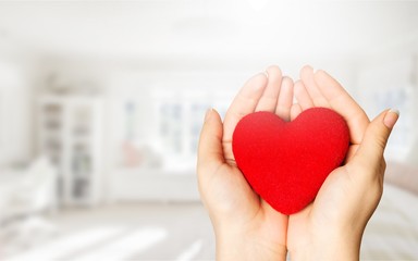 Fototapeta premium Hands of young woman holding red heart