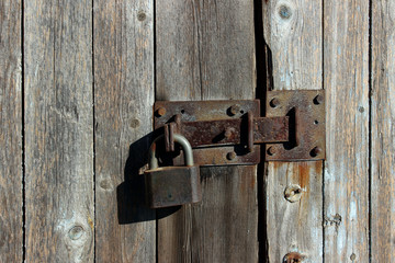 Old Wooden Fence. Close Up Shot Of Wooden Wall. Iron Lock On Wooden Door.