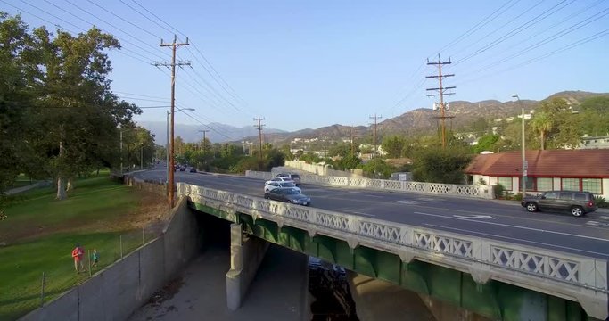 Aerial Moving Toward Traffic On Green Bridge