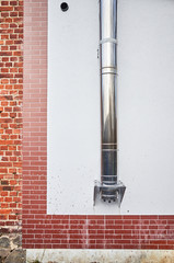 Chimney pipe coming out of a building wall
