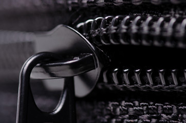 Black textile accessories material zipper metal macro on blur background © Kabardins photo