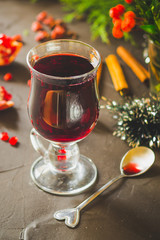 Mulled wine with spices and gifts on the table. Happy New Year! Top view
