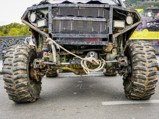 closeup front view of dirty black off-road car