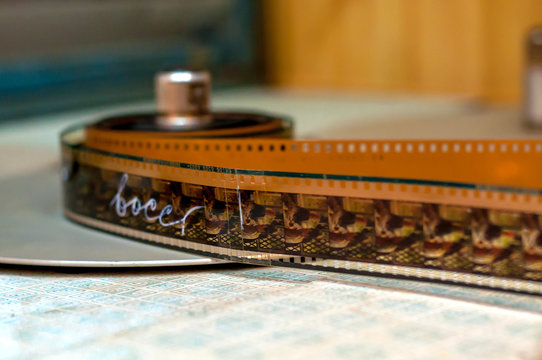 The film on the reel lies on the table in the film studio.