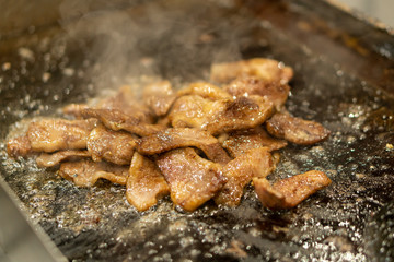 Japanese chef cooking wagyu beef with sauce in the kitchen to serve gourmet restaurant meal, delicious grill meat