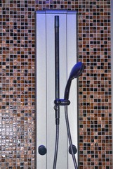Photo of chrome metal shower fixed on the wall