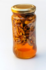 Honey with nuts surrounded by white background