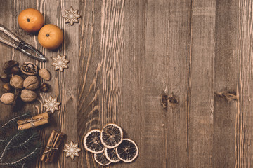 Wooden Christmas background with nuts and oranges 