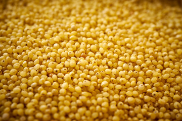close up view on spilled, yellow millet