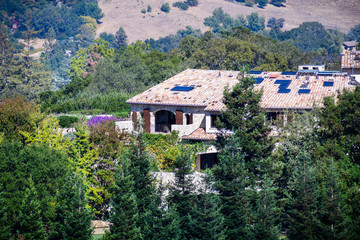 Fototapeta na wymiar Beautiful mansion surrounded by trees on the hills surrounding San Francisco bay area, California
