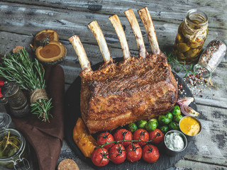 Grilled roasted rack of lamb,mutton with vegetables on a wooden surface