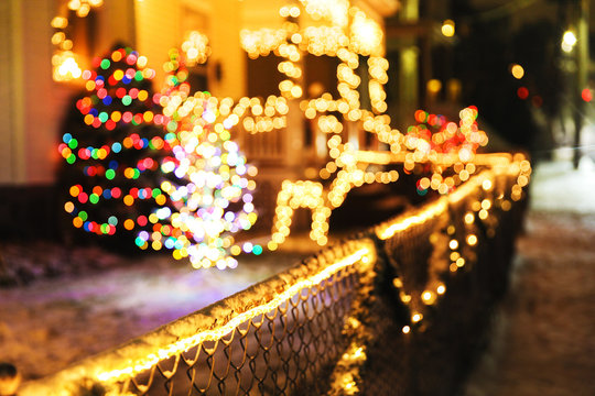shiny Christmas decorations outside at night. blurred background city street with Christmas illuminations. Cope space for your text