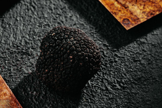 Black truffles mushroom on a textured copper background. close-up. Truffle in section. macro photography. gourmet vegetable