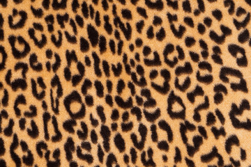 Faux fur leopard texture background. Fashionable modern ecological material.