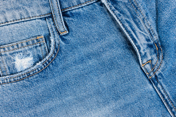 Fototapeta premium Blue jeans cotton texture. Close up view on fifth pocket and fly.