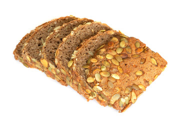 Healthy sliced bread with pumpkin seed isolated on a white background. Bread slices and crumbs viewed from above. Top view