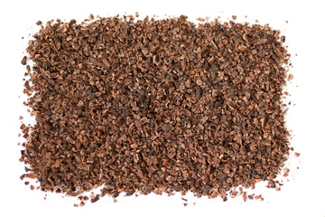 Backgroundof cacao nibs, isolated on white background, top view