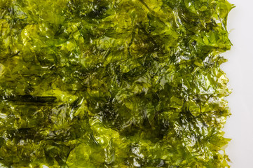 nori chips on a white ceramic plate, seaweed sheets © Wingedbull