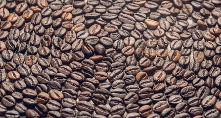 Roasted coffee beans on the background of linen fabric