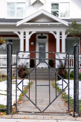 Fototapeta na wymiar Black iron fence closeup in front of house
