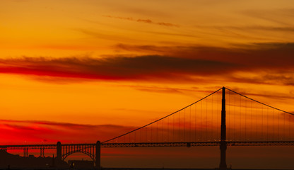 Golden Gate Bridge in silhouette at sunset