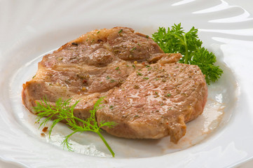 Стейк из свинины на тарелке Pork steak on a plate