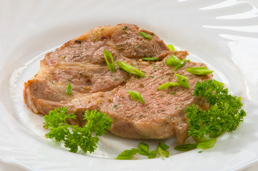 Стейк из свинины на тарелке Pork steak on a plate