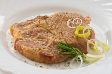 Стейк из свинины на тарелке Pork steak on a plate