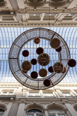 Vertical shot of decoration hanging from the ceiling of an indoor shopping passage
