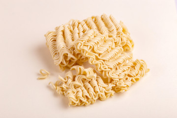 Uncooked instant noodles on white marble background