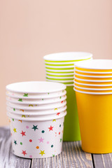 Recycling bright and colorful paper cups on wooden table