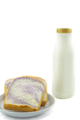 bottle of milk and sliced bread on white background