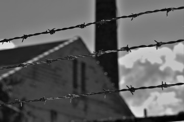 barbed wire fence in front of factory