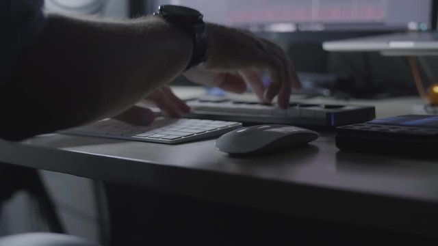 DJ producer musician plays a MIDI keyboard in a studio