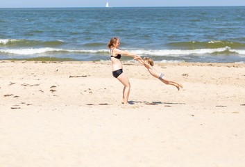 Mother and son spending time on sea shore