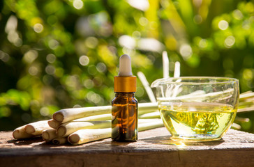 Lemongrass essential oil is placed on the table using a hand-drip oil lemongrass oil - spa and insect repellent.