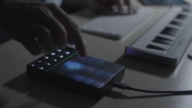 DJ Producer musician sets up the drum pad and create a drum beat