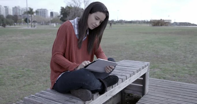 Woman with Ipad outdoors – 4k