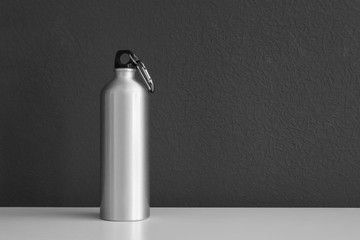Aluminum water bottle for sports on gray background. Space for text