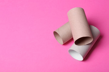 Empty toilet paper rolls and space for text on color background