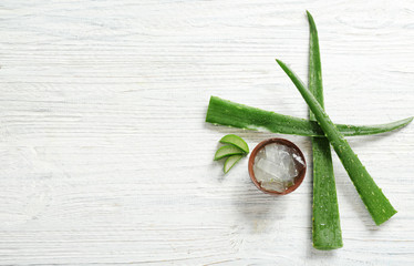 Flat lay composition with aloe vera leaves on wooden background. Space for text - obrazy, fototapety, plakaty