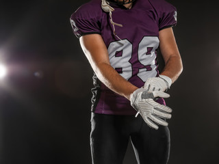 American football player wearing uniform on dark background, closeup © New Africa