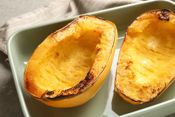 Cooked spaghetti squash in baking dish on table, closeup