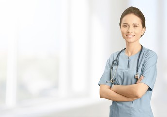 Male doctor with stethoscope on blurred hospital background