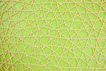woven mesh of artificial material on green background