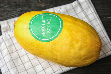 Whole ripe spaghetti squash on dark table