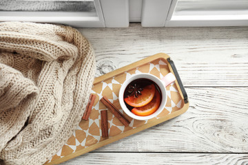 Flat lay composition with cup of hot winter drink on wooden sill near window. Cozy season